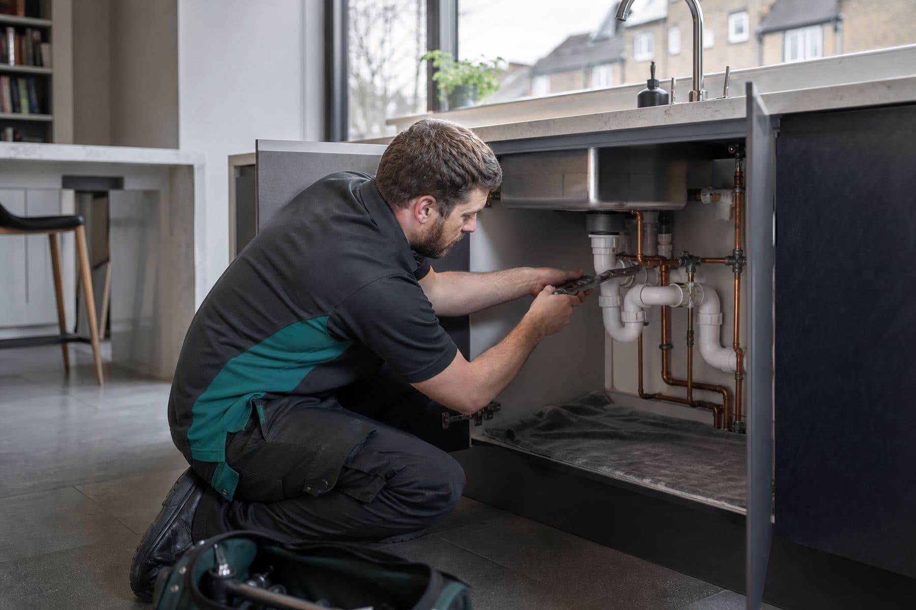 Plumbing — GEM operative at work on a London property